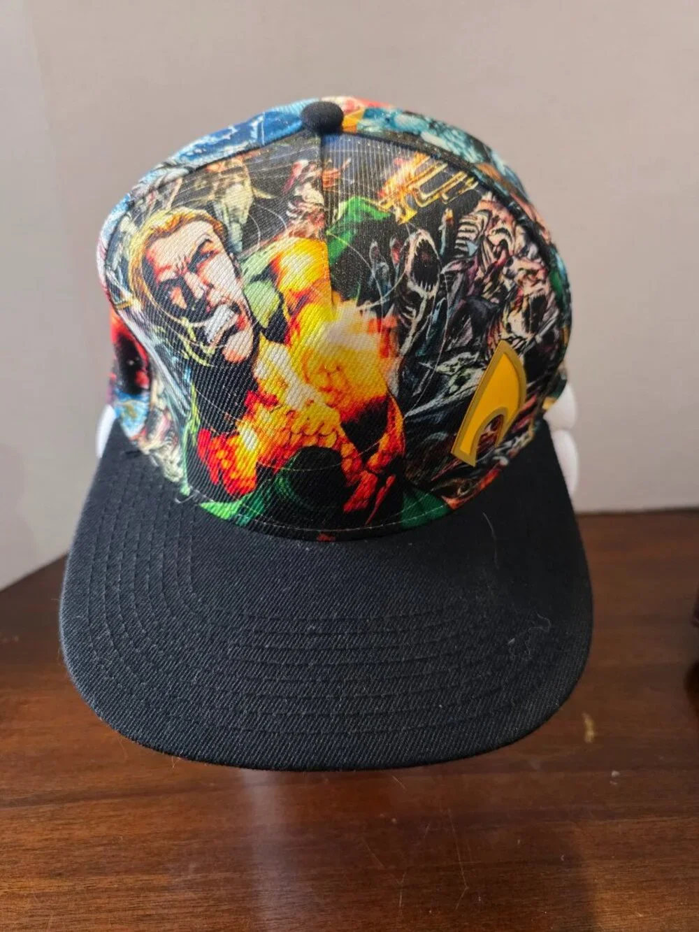 Bioworld DC Comics snapback hat features a vibrant sublimated graphic print of